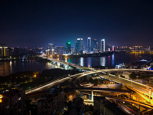 istock Nighttime Urban Intersection with Illuminated Roads and Buildings 2227874996