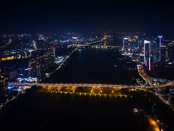 Nighttime Cityscape with River and Illuminated Buildings
