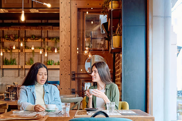 istock Two young women talking and drinking coffee in a restaurant 2227876692