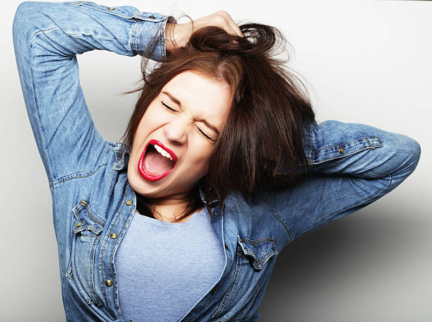 istock frustrated and angry woman screaming. 2227876899