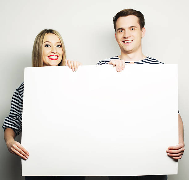 istock Couple holding a banner 2227876948