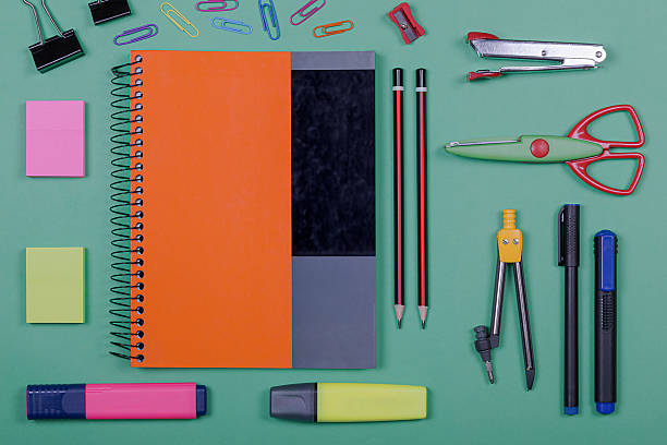 istock School supplies on a green background, includes notebook, scissors and several other stationery items. 2227877106