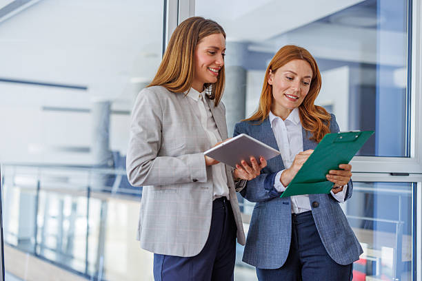 istock Businesswomen collaborating using digital tablet and clipboard in office 2227877178