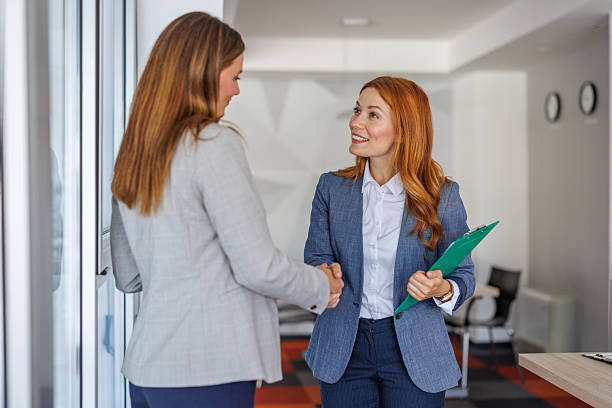 istock Two businesswomen shaking hands in modern office 2227877183