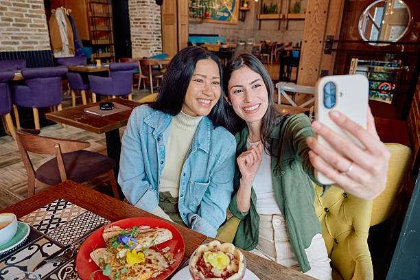 istock Two young women taking a selfie while having brunch at the restaurant 2227877200