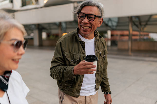 istock Smiling Senior Couple Walking Through Streets 2227877868