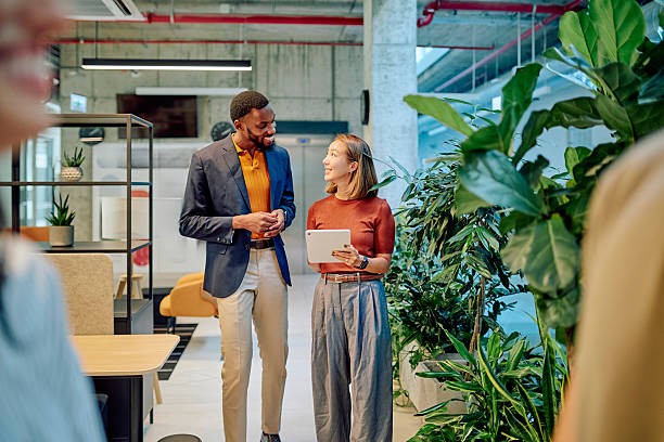 istock Managers walking and talking in modern green office 2227879354