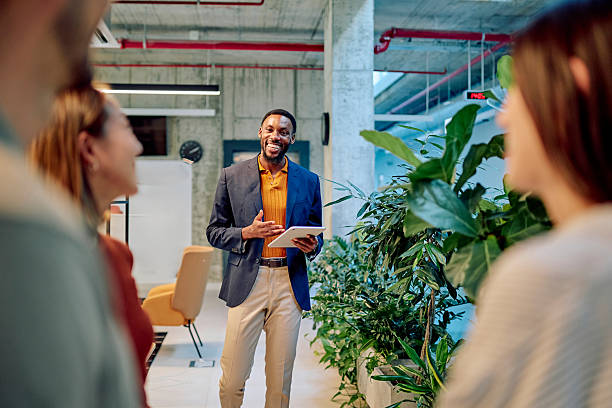 istock Manager holding tablet is leading a meeting with his team in the office 2227879401