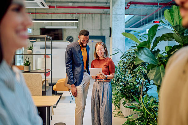 istock Business partners using tablet in modern green office space 2227879408