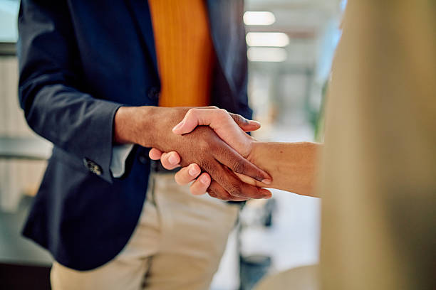 istock Business people shaking hands in modern office building 2227879831