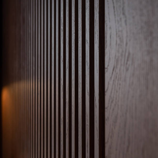 istock Brown wooden louvers inside a dark room creating a  striped background. 2227880306