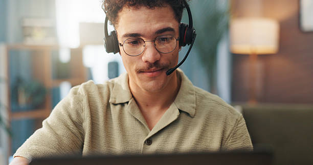 istock Video call, remote work and man with headset on laptop for conversation, online chat and virtual meeting. Communication, working from home and person for discussion, talking and webinar on computer 2227880438