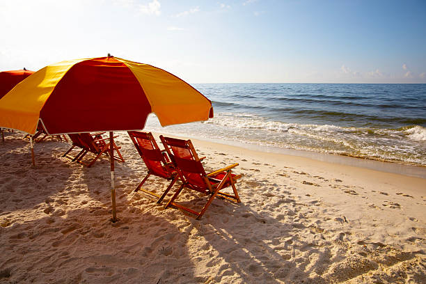 Colorful Beach Umbrella at Sunrise on the Beach. Shot in Gulf Shores, Alabama with a Canon EOS Mark V camera.