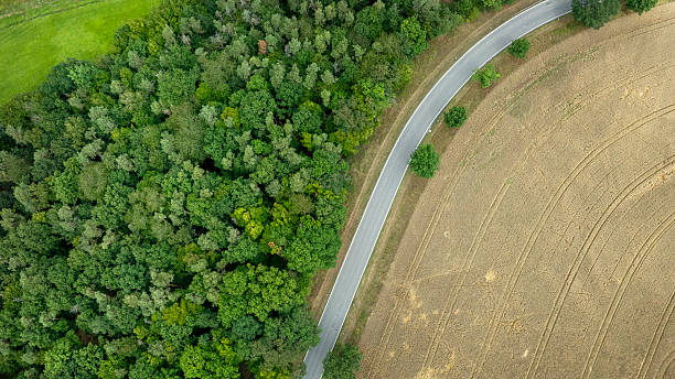istock Road through a rural scene - aerial view 2227882584