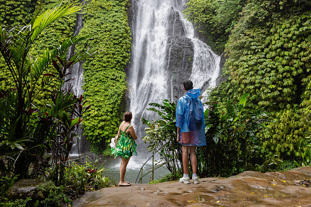 istock Mother and son looking towards waterfall in Bali 2227884451