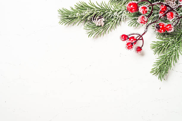 istock Winter fir tree with snow and decorations at white table. 2227884754