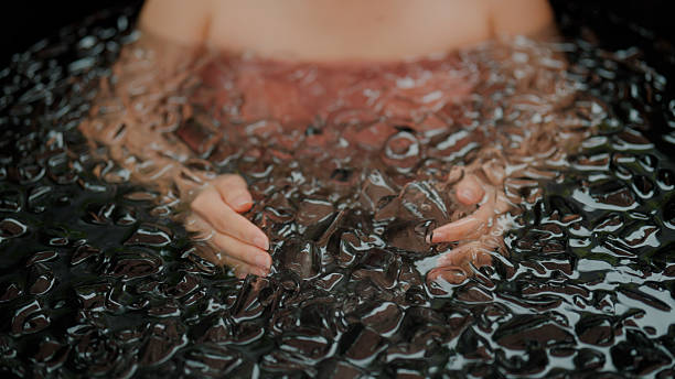 istock Young Asian woman playing with ice cubes while having an ice bath therapy. 2227884920