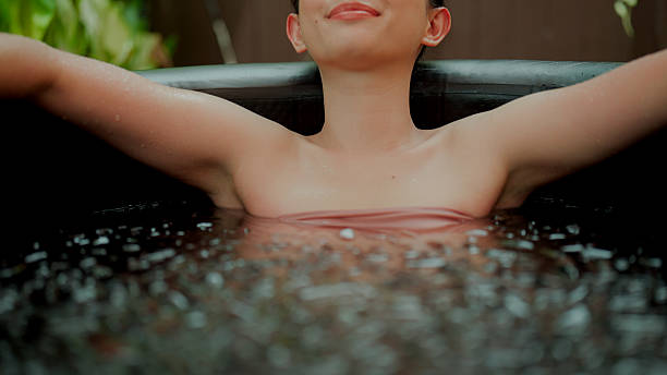 istock Young Asian woman smiling while relaxing in an ice bath therapy. 2227885142