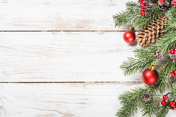 istock Winter fir tree with snow and decorations at white table. 2227886346