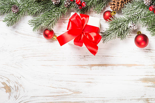 istock Winter fir tree with snow and decorations at white table. 2227886378