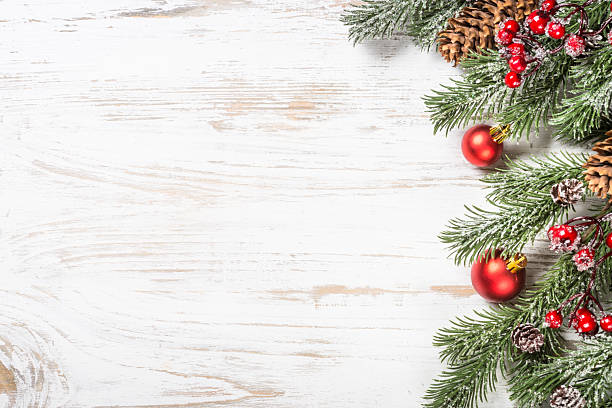 istock Winter fir tree with snow and decorations at white table. 2227886655