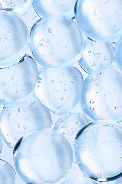 istock Transparent blue water bubbles floating in clear liquid. Vertical abstract 3D background, symbolizing purity, hydration, and freshness. Ideal for skincare, cosmetics, science, or wellness concepts. 2227888427