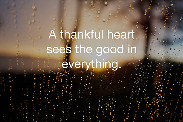 istock Raindrops on windscreen with inspirational quotes A thankful heart sees the good in everything 2227891124