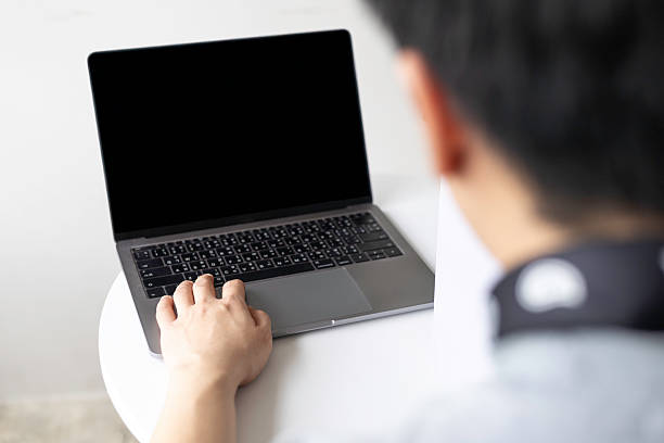 istock Man using laptop with blank screen for mockup. Over the shoulder view, isolated on white background with clipping path. 2227891260