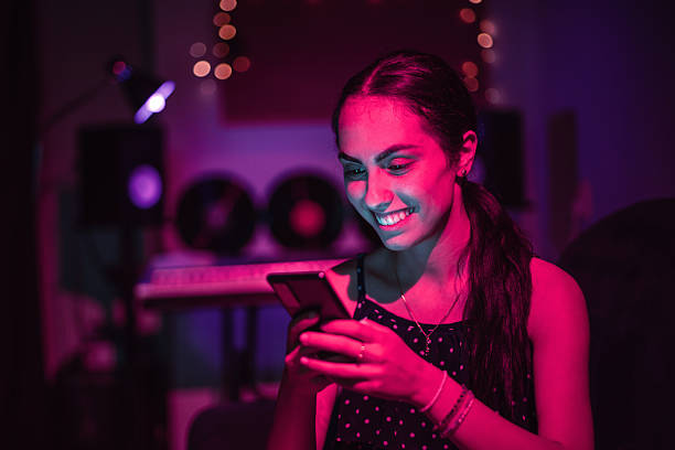 istock Young woman using a phone in a recording studio 2227892720