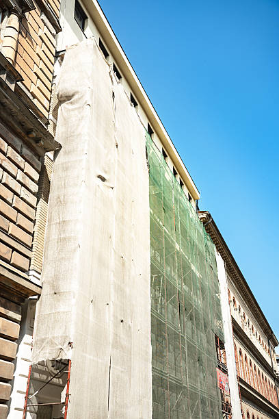 Low angle view of extensive wooden scaffolding on building during reconstruction. Copy space for your text. Soft focus. Construction site background theme.