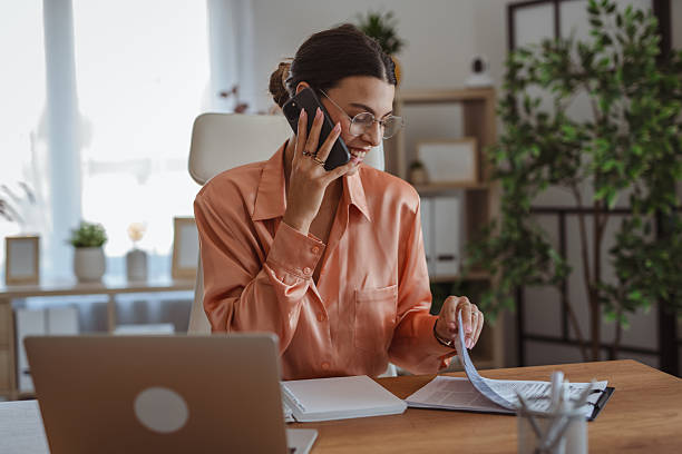istock Businesswoman working from home talking on phone and taking notes 2227899715