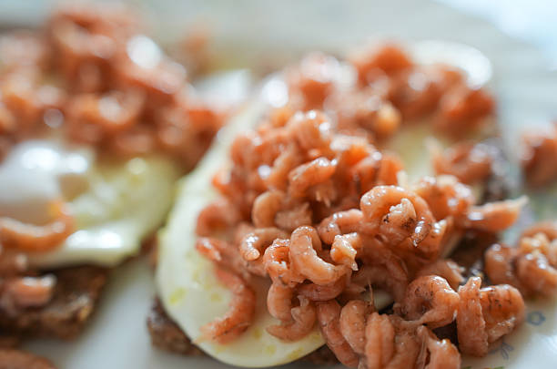 Fresh North Sea shrimps served on crispy toasted bread, topped with a perfectly fried egg. Classic Northern German seafood delicacy