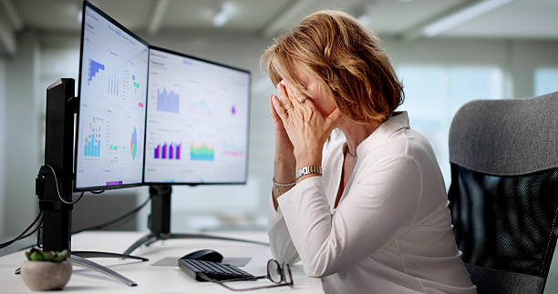 istock Distressed Accountant Holds Head In Hands, Surrounded 2227904761