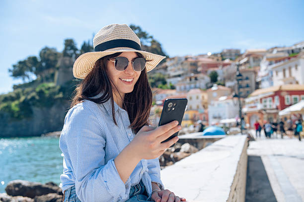 istock Woman on a summer seaside vacation using her phone. 2227905619
