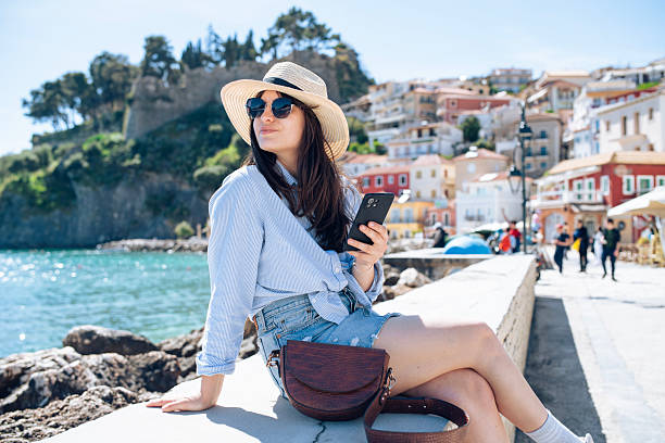istock Woman on a summer seaside vacation using her phone. 2227905625