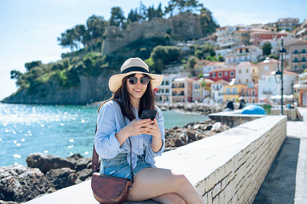 istock Woman on a summer seaside vacation using her phone. 2227905626