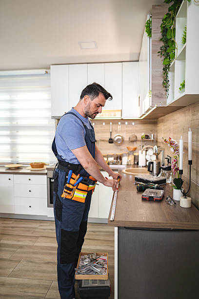 istock Handyman measuring countertop in modern kitchen using measuring tape 2227906727