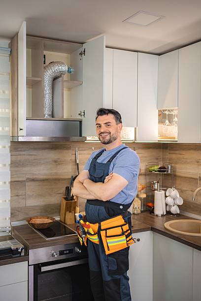 istock Handyman smiling with crossed arms after installing range hood in kitchen 2227906780
