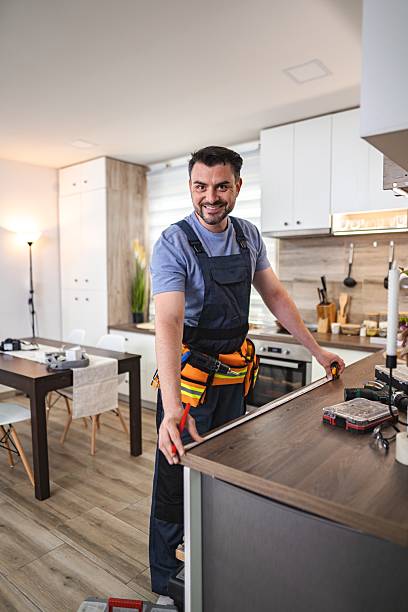 istock Carpenter taking measurements of kitchen counter in a modern apartment 2227906848
