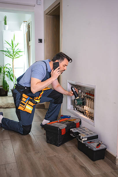 istock Plumber inspecting pipes and talking on the phone 2227906870
