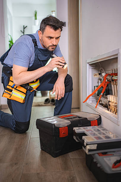 istock Plumber inspecting plumbing system with flashlight in a residential building 2227906906