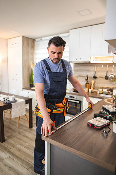 istock Carpenter measuring wooden kitchen countertop using tape measure 2227906909