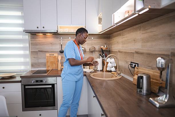 istock Nurse washing a glass in the kitchen sink 2227907001