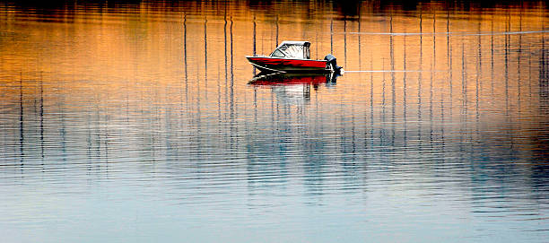 istock Boat on River Reflection of Trees and Sky Fall Autumn Trees 2227907976