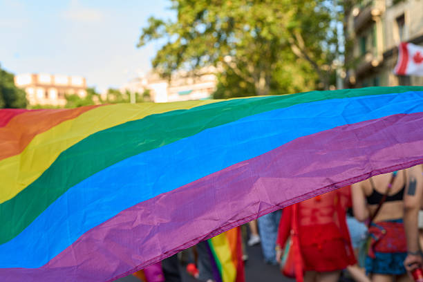 istock Rainbow flag waving at pride parade celebrating lgbtq+ rights 2227908349