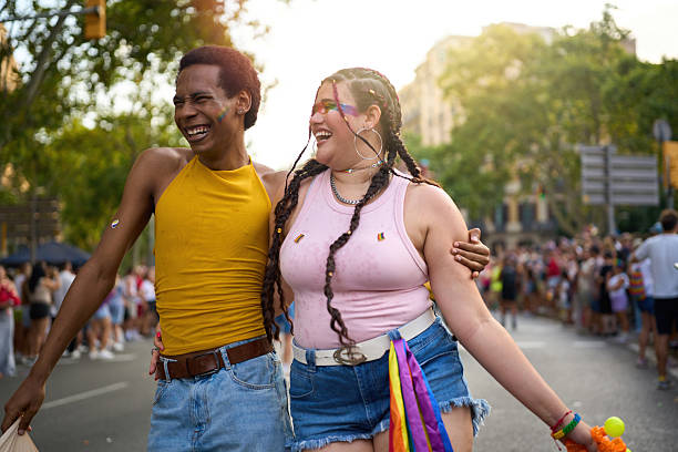 istock Young couple walking together at pride parade 2227908401