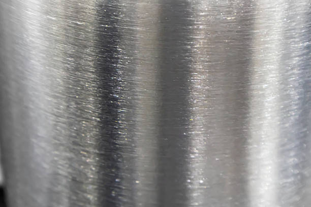 Background image of stainless steel surface with rough texture.