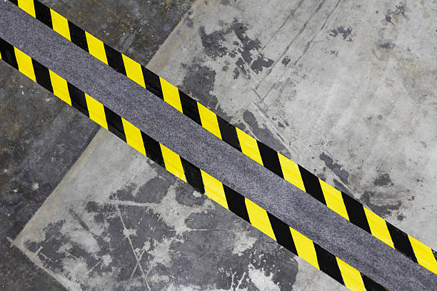 istock Concrete wall with yellow and black warning stickers 2227909502