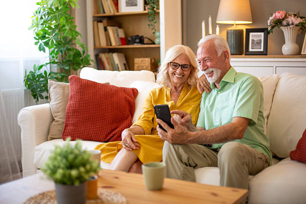 istock Happy senior couple using smartphone at home, enjoying retirement 2227911967