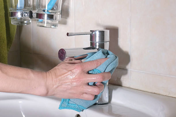 istock Wiping bathroom faucet with microfiber cloth 2227913174